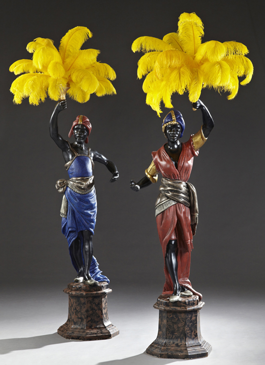Pair of early 20th century parcel gilt polychrome carved wood blackamoor torcheres on marble stepped bases, both 80 inches tall. Estimate: $4,000-$6,000. Crescent City Auction Gallery image.